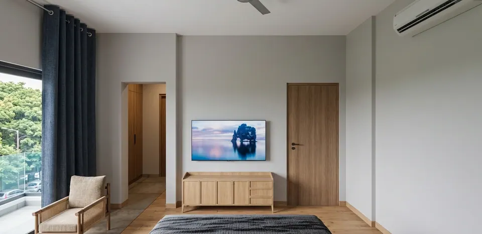 Rendered bedroom: a low oak sideboard under a wall-mounted TV, an armchair by the balcony door and trees outside