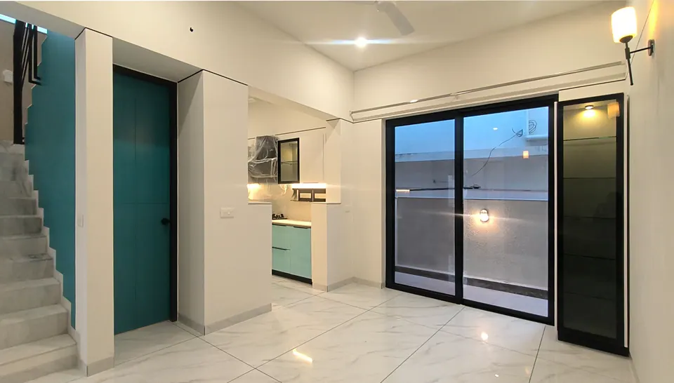 Hall with the teal-walled stair, a teal door, a kitchen with mint-green cabinets and black-framed sliding doors