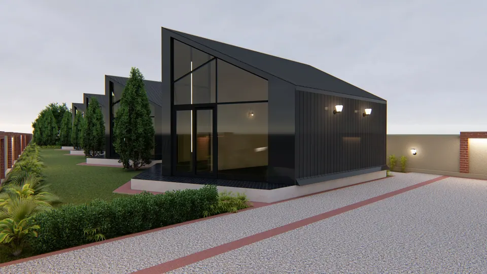 Rendered black-clad gabled pavilion with a fully glazed gable end beside a gravel drive edged in brick, at dusk