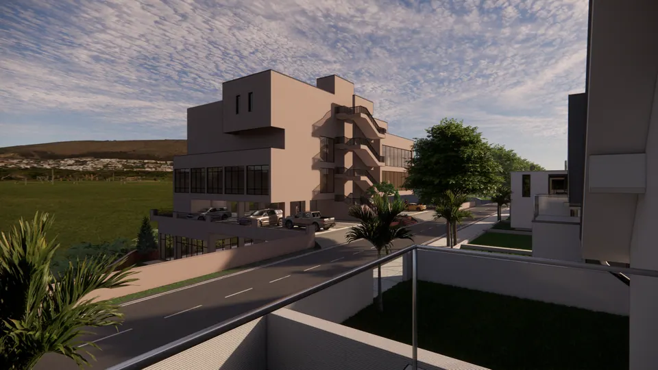 Rendered club house seen across a lawn from a neighbouring terrace, the road curving past