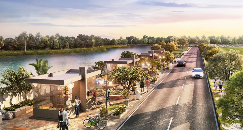 Rendered road along a lake with open-sided cafe kiosks, seating and cyclists at sunset