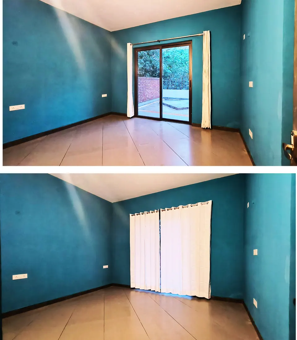 Teal-walled room with a wooden floor and a glazed door open to a terrace